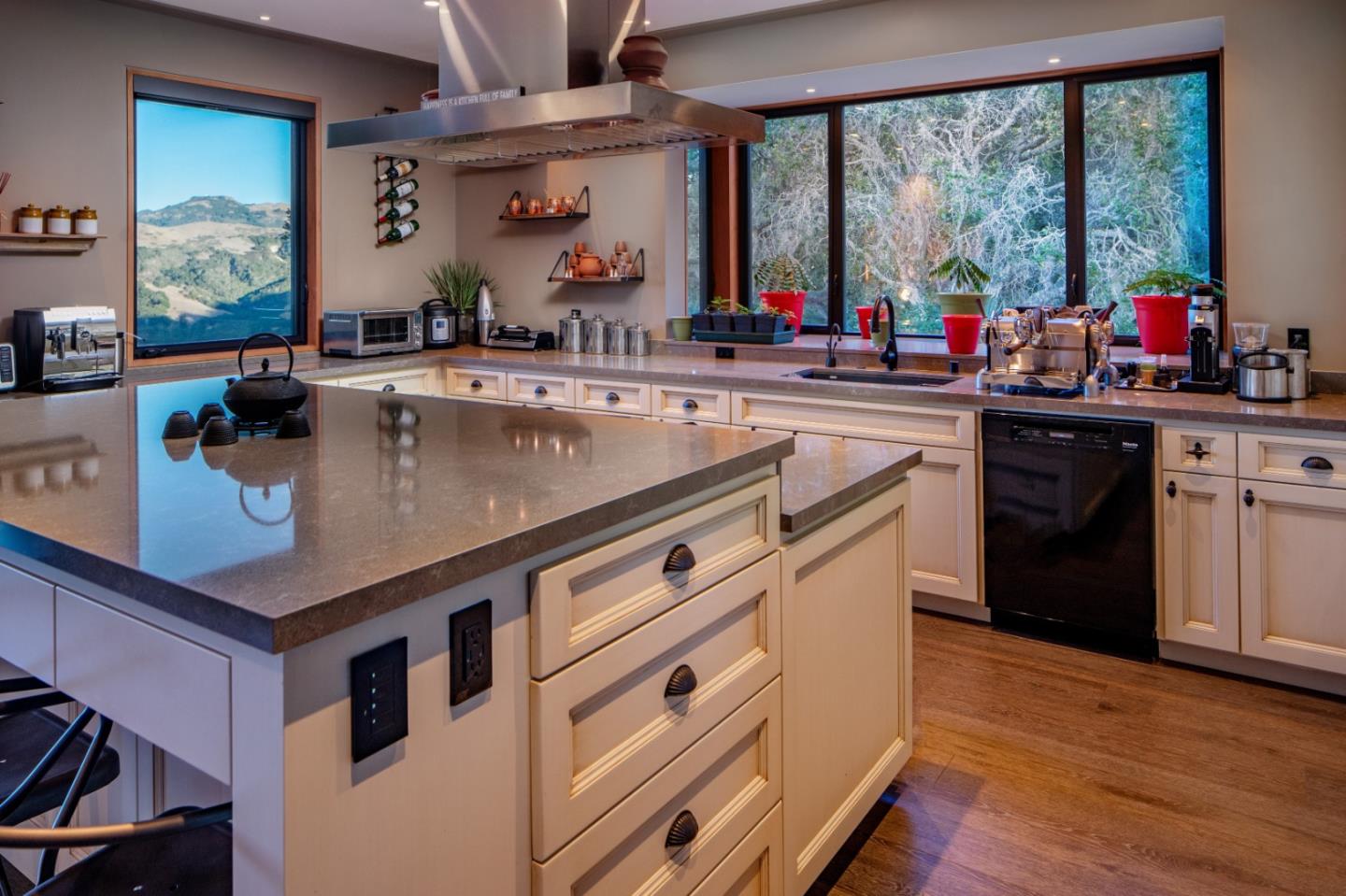 32 Potrero Trail Carmel, CA 93923 - Photo 4 of 14 a kitchen with a stove a sink dishwasher and a dining table with wooden floor