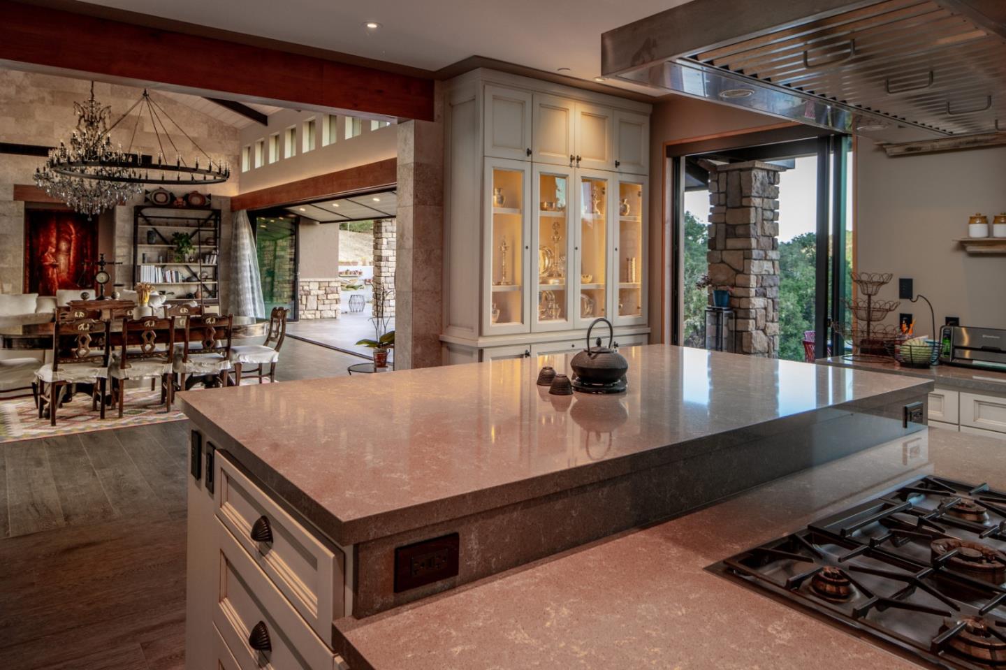 32 Potrero Trail Carmel, CA 93923 - Photo 5 of 14 a kitchen with a stove a sink and a dining table with wooden floor