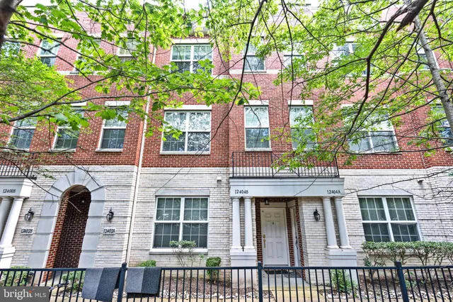 a front view of a building with a garden
