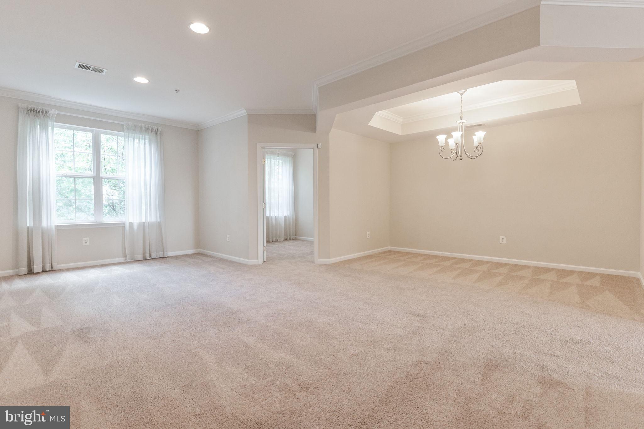 12404 B Liberty Bridge Road, Unit 12404B Fairfax, VA 22033 - Photo 12 of 43 a view of an empty room with a window