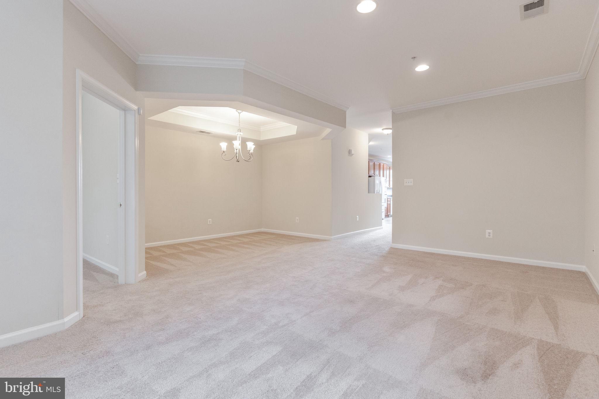 12404 B Liberty Bridge Road, Unit 12404B Fairfax, VA 22033 - Photo 13 of 43 wooden floor in an empty room with a window