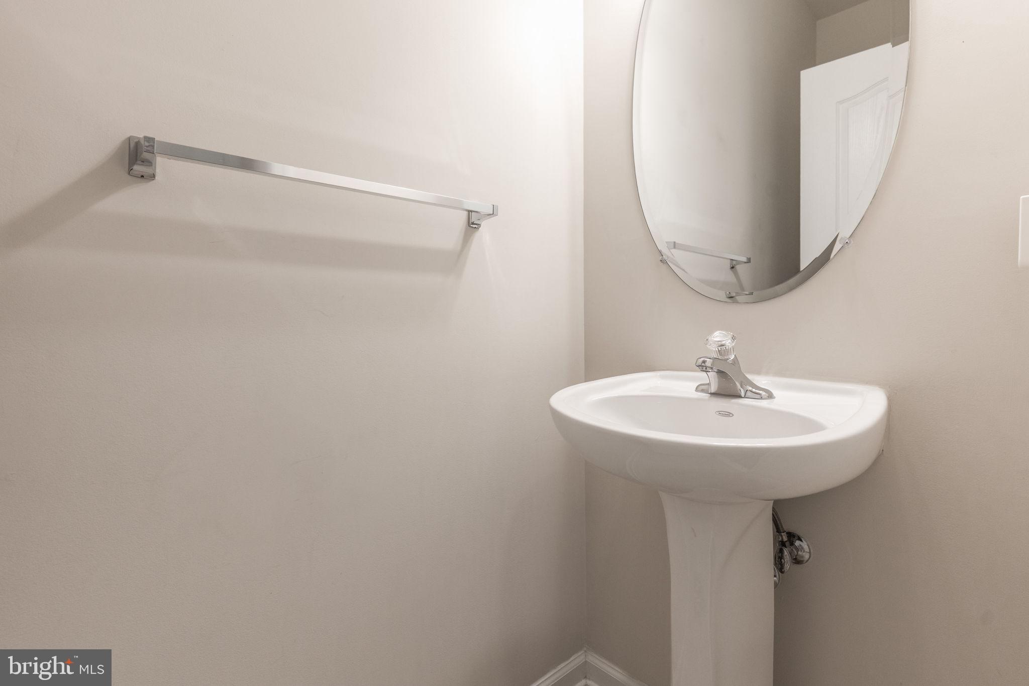 12404 B Liberty Bridge Road, Unit 12404B Fairfax, VA 22033 - Photo 14 of 43 a bathroom with a sink a mirror and vanity