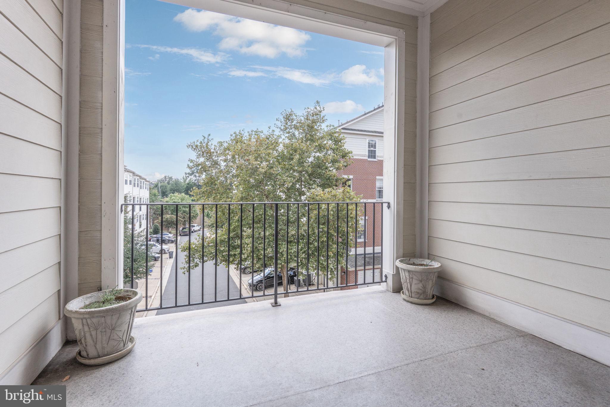 12404 B Liberty Bridge Road, Unit 12404B Fairfax, VA 22033 - Photo 17 of 43 a view of a porch with furniture and floor to ceiling window