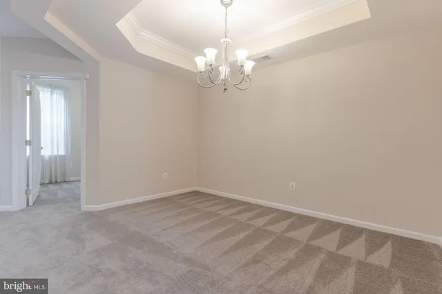 a view of an empty room with a chandelier