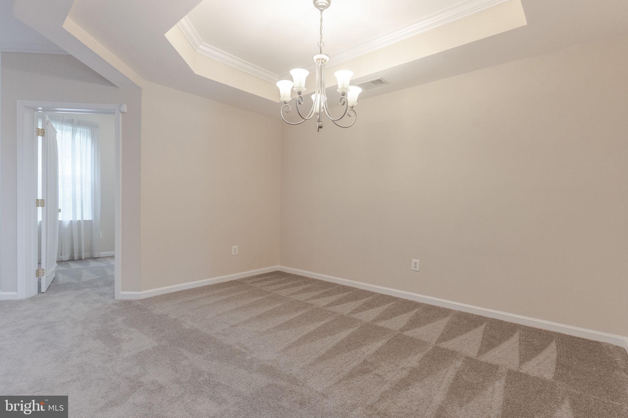 12404 B Liberty Bridge Road, Unit 12404B Fairfax, VA 22033 - Photo 18 of 43 a view of an empty room with chandelier fan
