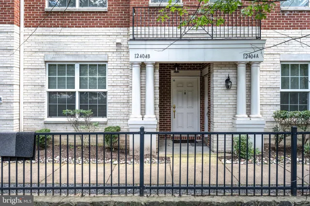 a view of a house with a wooden fence