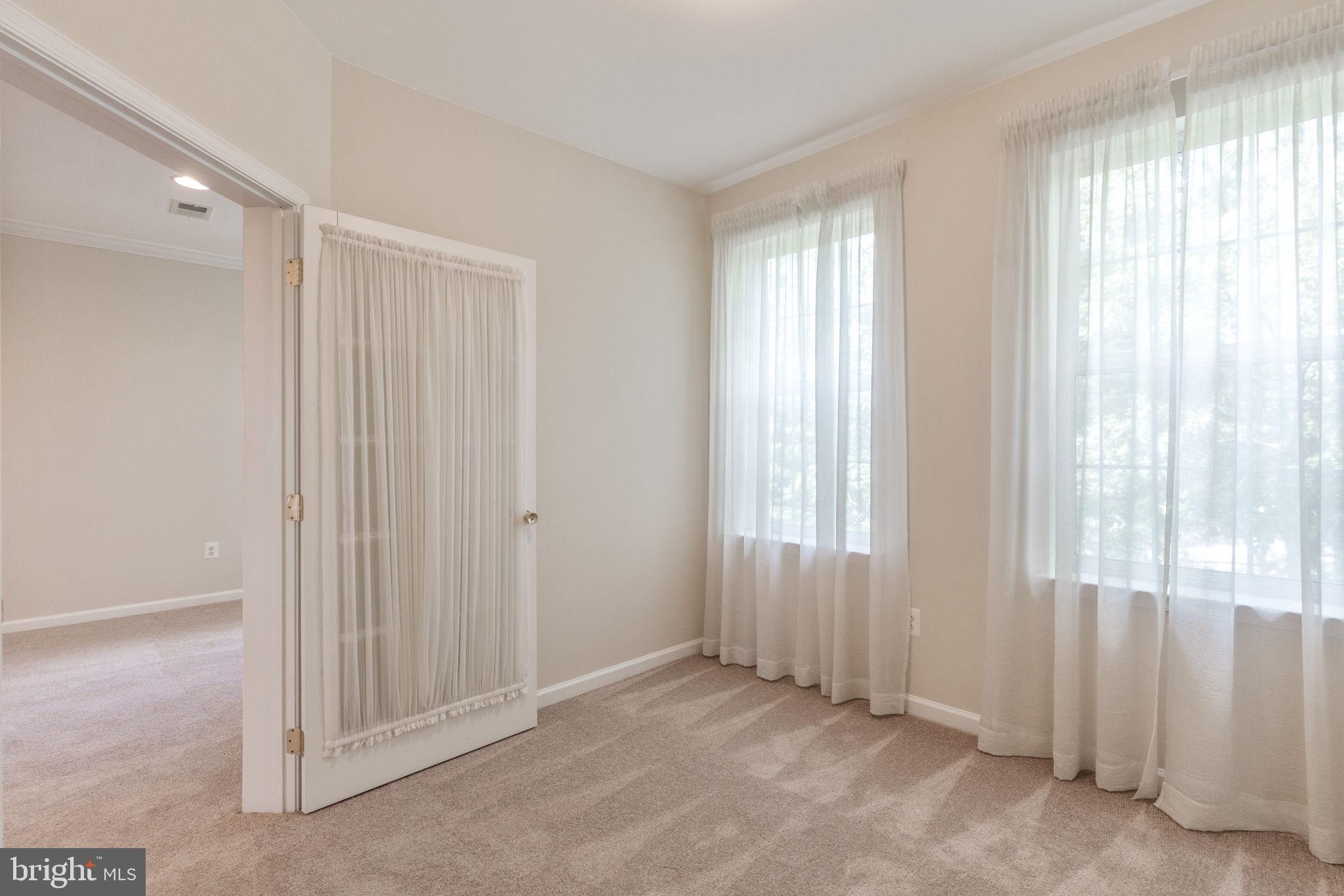 12404 B Liberty Bridge Road, Unit 12404B Fairfax, VA 22033 - Photo 22 of 43 a view of an empty room with a window