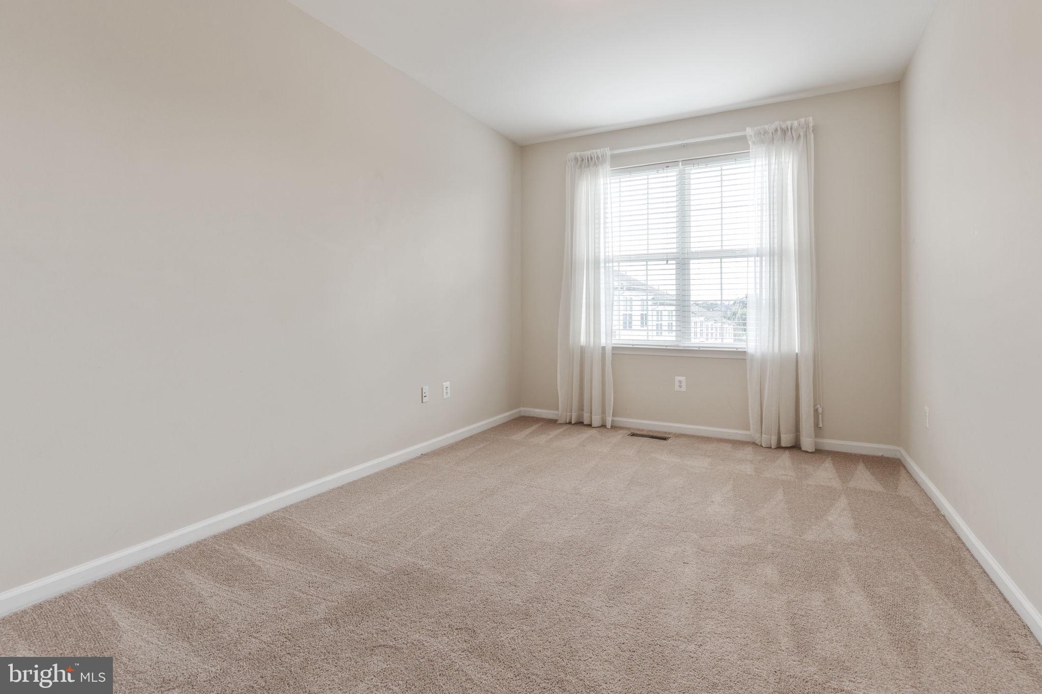 12404 B Liberty Bridge Road, Unit 12404B Fairfax, VA 22033 - Photo 26 of 43 an empty room with windows
