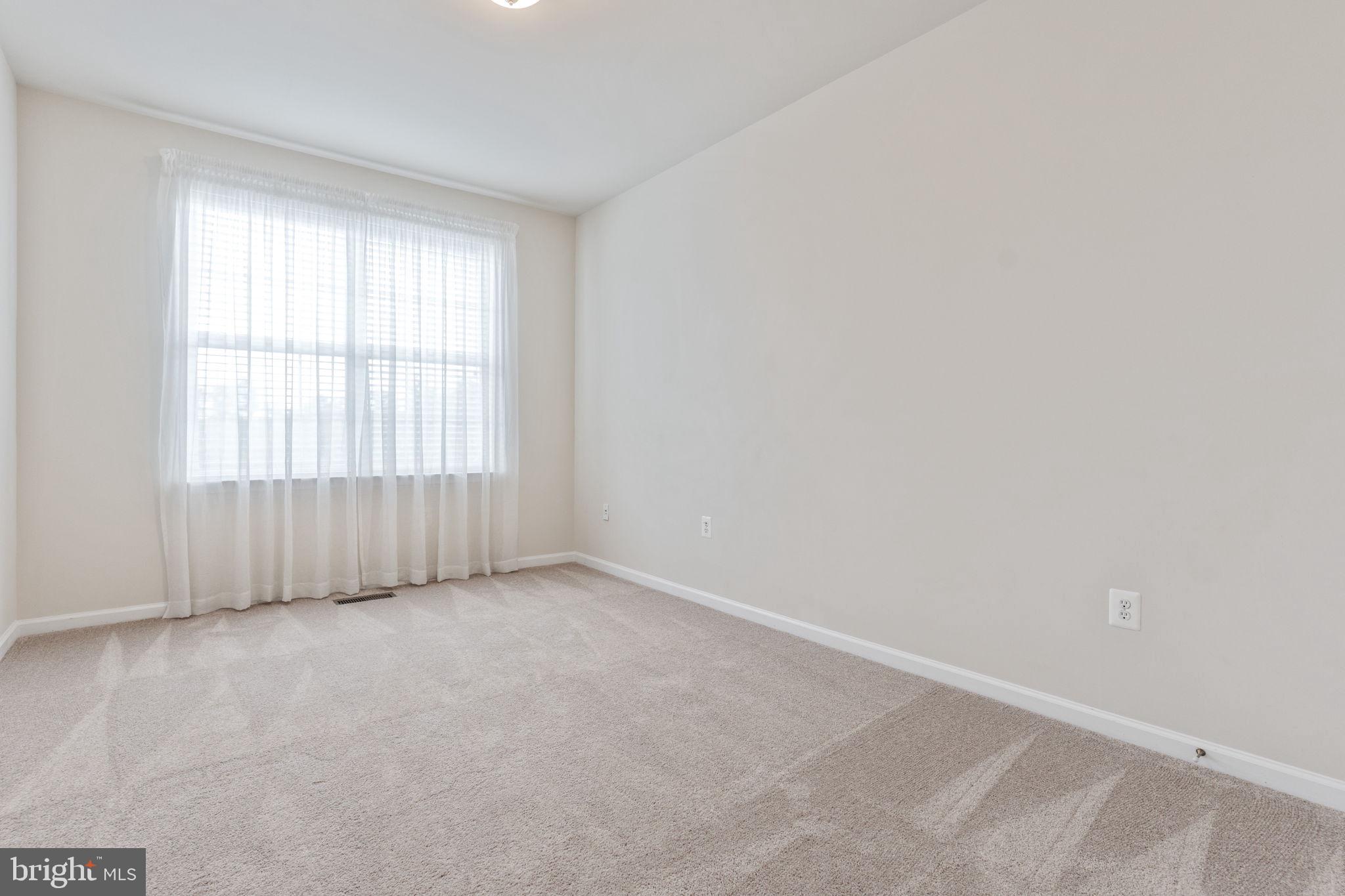 12404 B Liberty Bridge Road, Unit 12404B Fairfax, VA 22033 - Photo 28 of 43 an empty room with windows