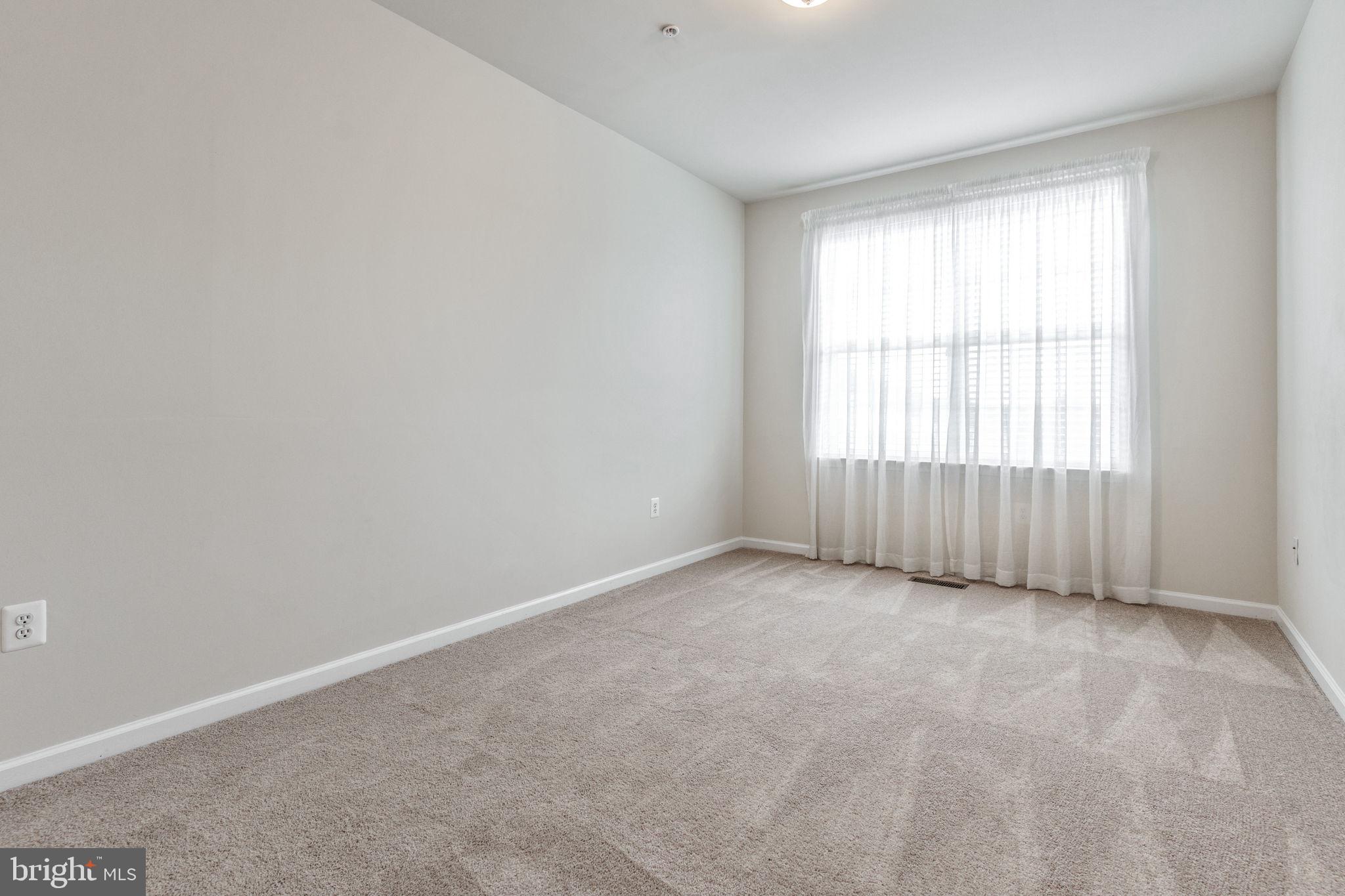 12404 B Liberty Bridge Road, Unit 12404B Fairfax, VA 22033 - Photo 29 of 43 an empty room with a window