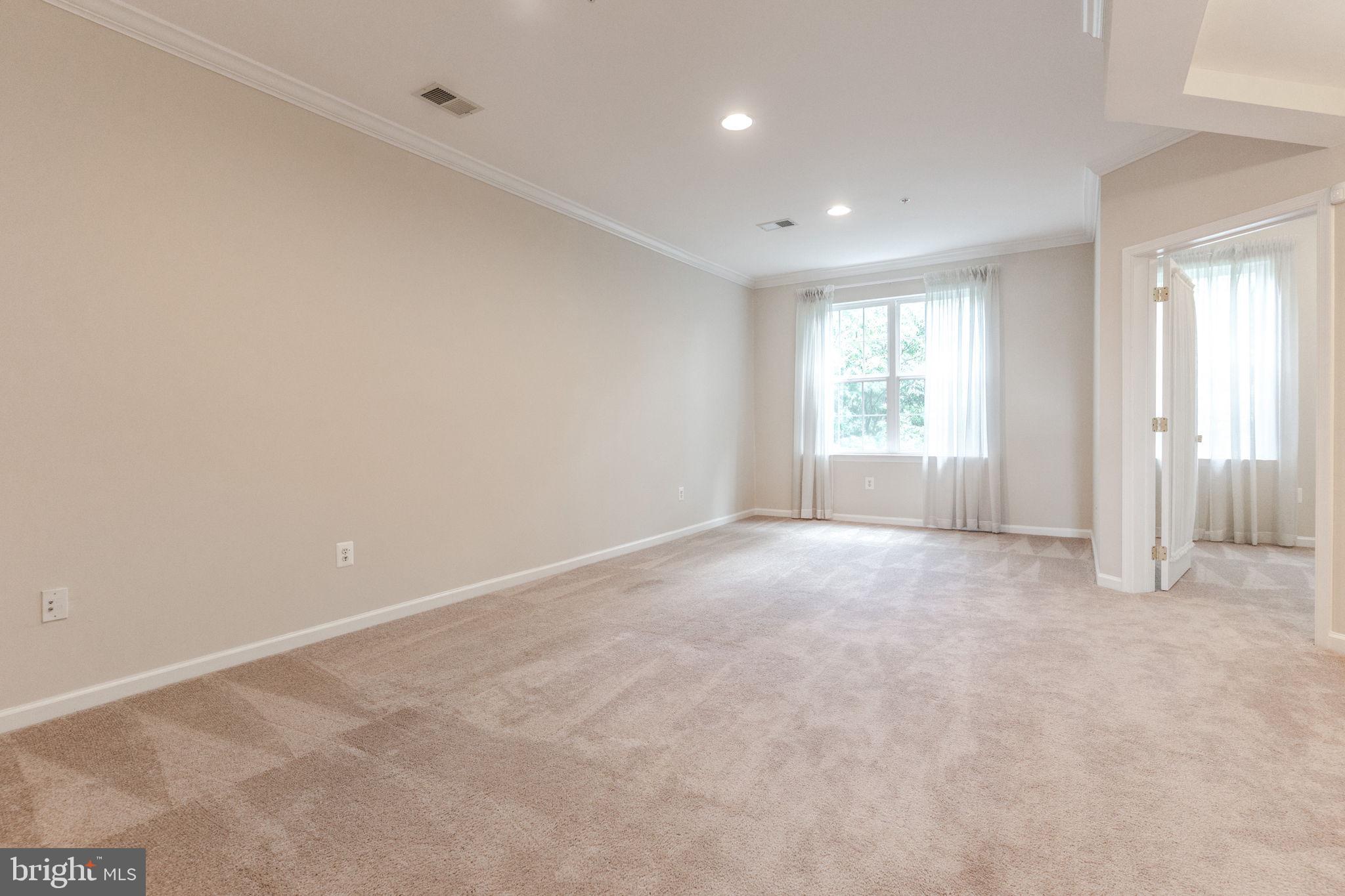 12404 B Liberty Bridge Road, Unit 12404B Fairfax, VA 22033 - Photo 32 of 43 an empty room with windows and closet