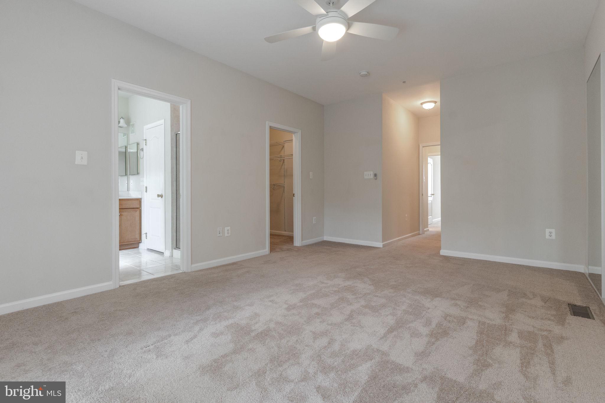 12404 B Liberty Bridge Road, Unit 12404B Fairfax, VA 22033 - Photo 35 of 43 a view of an empty room with a chandelier fan