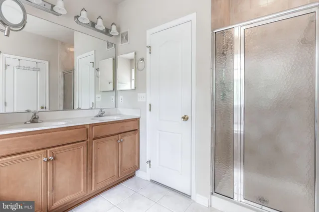 a spacious bathroom with a tub sink and mirror