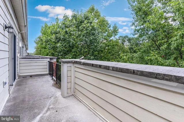 a view of a balcony with trees