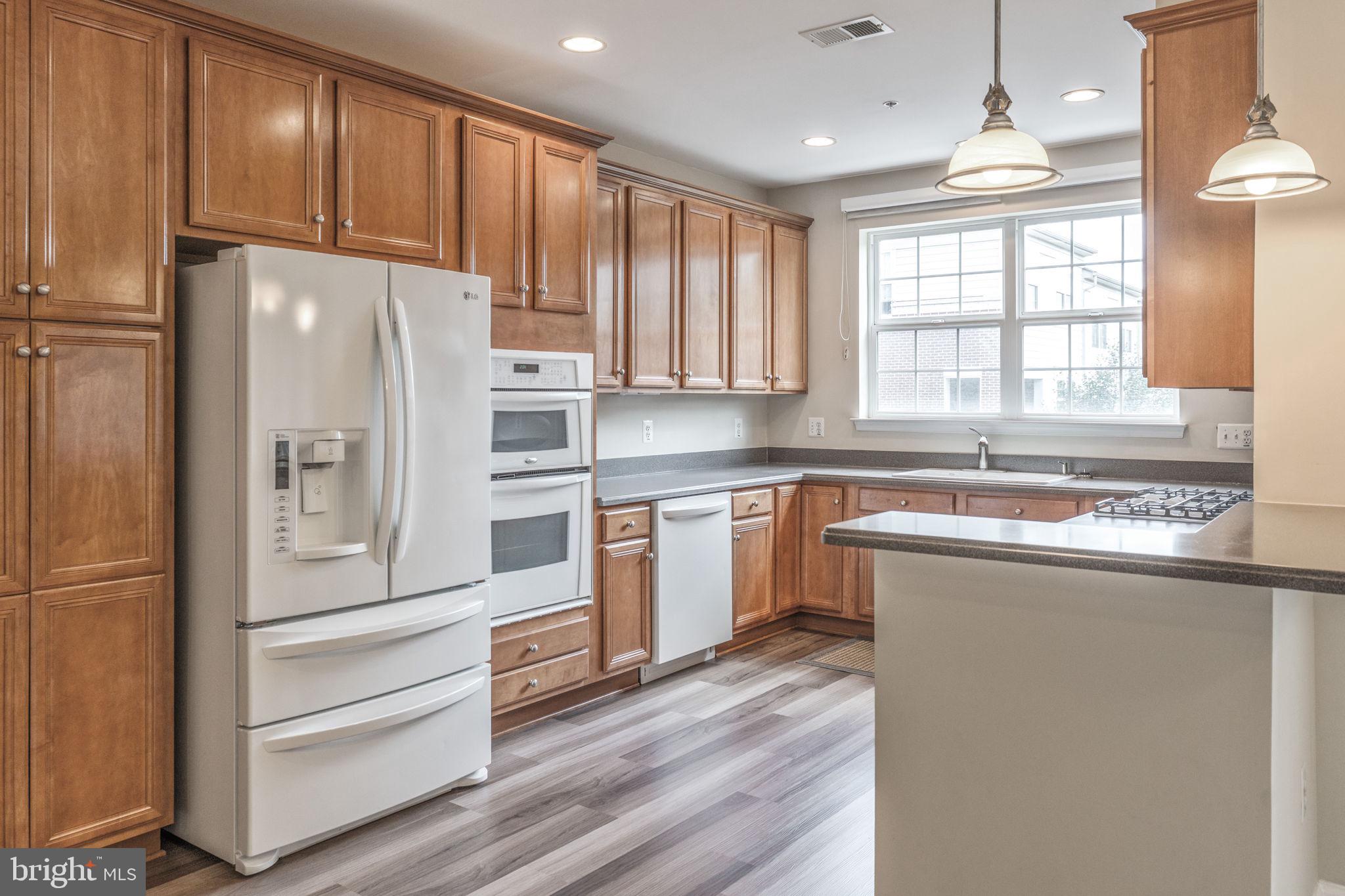 12404 B Liberty Bridge Road, Unit 12404B Fairfax, VA 22033 - Photo 7 of 43 a kitchen with granite countertop stainless steel appliances and window