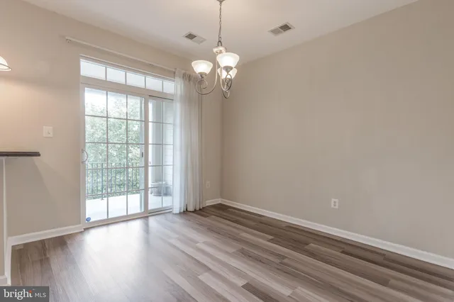 a view of a kitchen with wooden floor and a large window