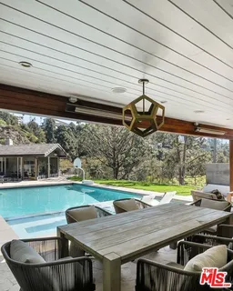 a view of a patio with table and chairs