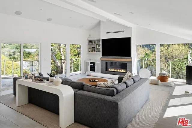 a living room with fireplace furniture and a flat screen tv
