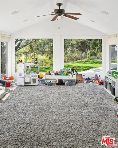 a view of a room with furniture and large windows