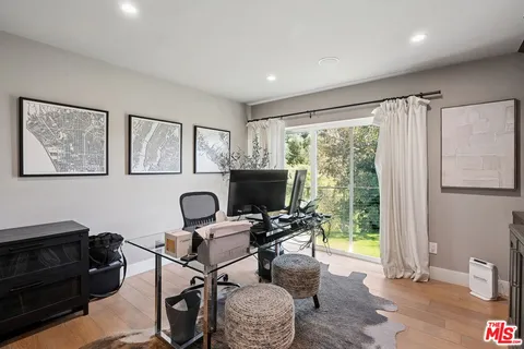 a work room with furniture and a flat screen tv