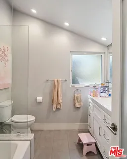 a bathroom with a sink a toilet and mirror