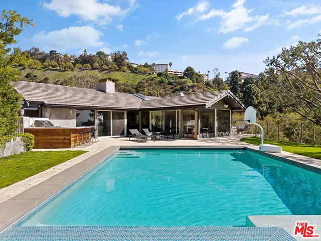 a front view of house with yard and swimming pool