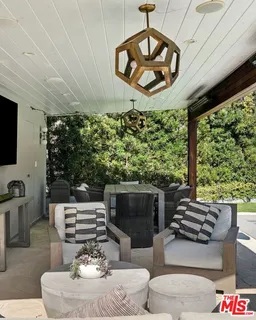 a living room with furniture a fireplace and a large window