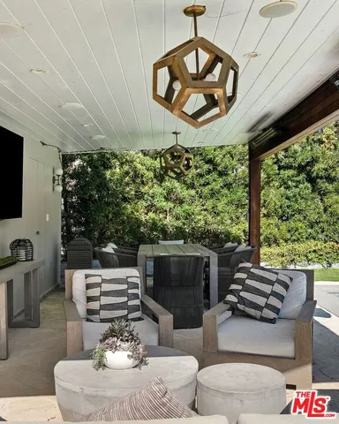 a living room with furniture a fireplace and a large window