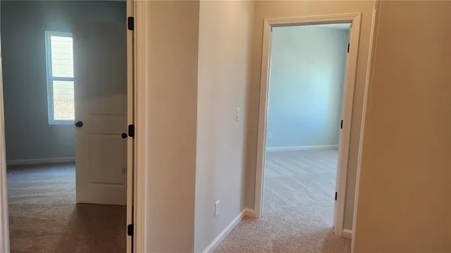 a view of a bathroom from a hallway