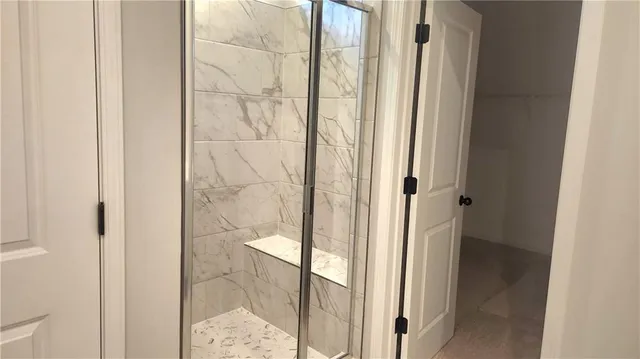 a bathroom with a glass shower door