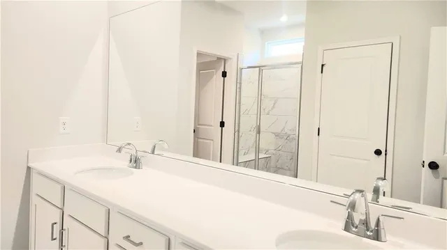 a bathroom with a sink and a large mirror