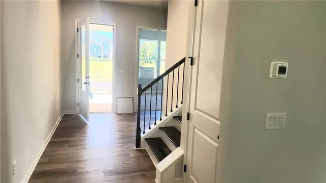 a view of entryway and hall with wooden floor