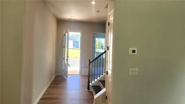 a view of a hallway with wooden floor