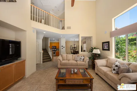 a living room with furniture tv and a flat screen tv