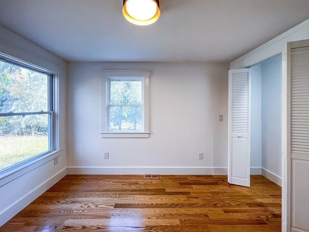 43 Oregon Road Ashland, MA 01721 - Photo 12 of 42 a view of an empty room with window and wooden floor