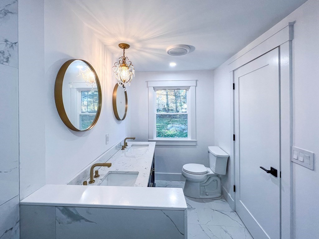 43 Oregon Road Ashland, MA 01721 - Photo 19 of 42 a bathroom with a toilet a sink and a mirror
