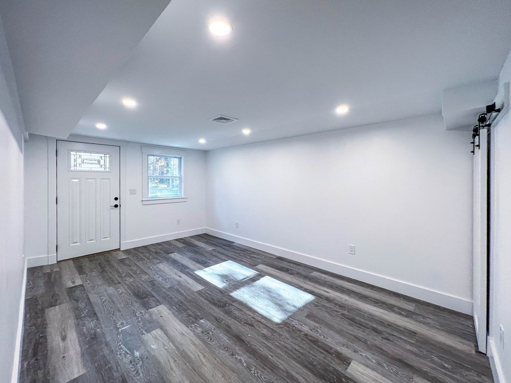 43 Oregon Road Ashland, MA 01721 - Photo 22 of 42 an empty room with wooden floor and windows