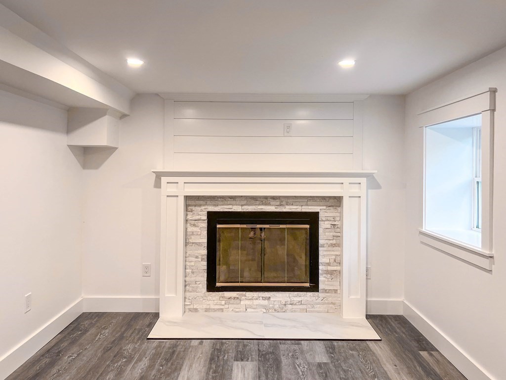 43 Oregon Road Ashland, MA 01721 - Photo 25 of 42 a an empty room with wooden floor and fireplace