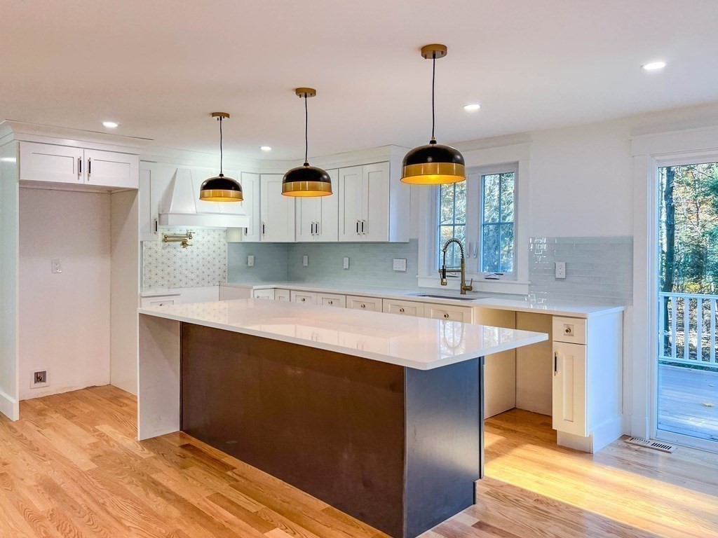 43 Oregon Road Ashland, MA 01721 - Photo 3 of 42 a kitchen with stainless steel appliances granite countertop a sink a stove and a wooden floor