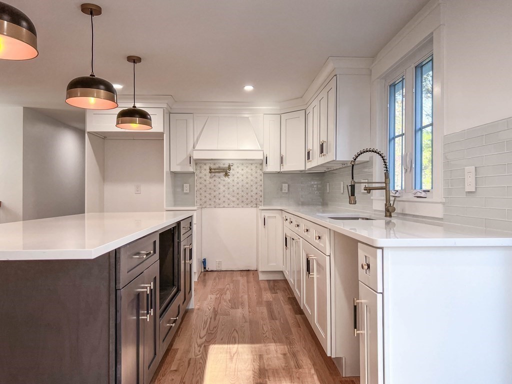 43 Oregon Road Ashland, MA 01721 - Photo 4 of 42 a kitchen with kitchen island granite countertop a sink a counter space appliances and cabinets
