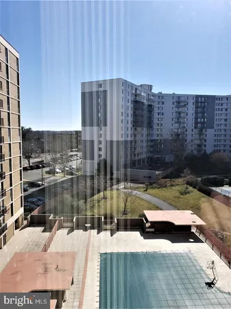 a view of swimming pool with outdoor seating and yard in back