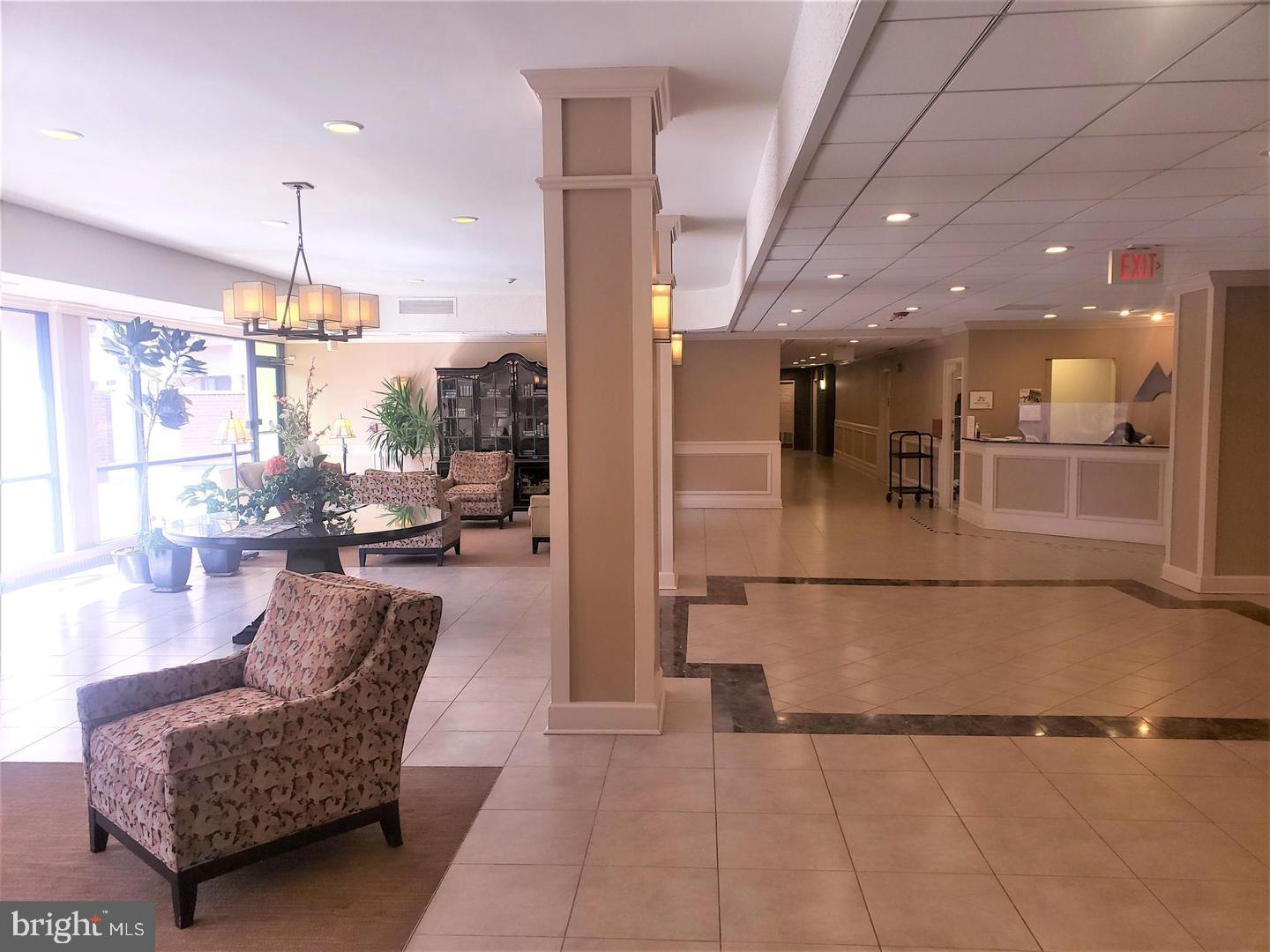 6800 Fleetwood Road, Unit 708 McLean, VA 22101 - Photo 29 of 35 Inviting lobby with natural light and greenery.