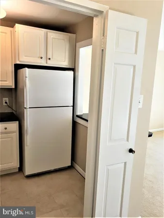 a white refrigerator freezer sitting in a kitchen