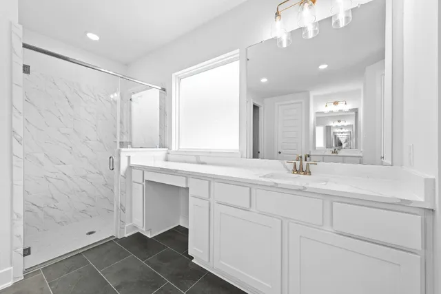 a bathroom with a double vanity sink mirror and shower