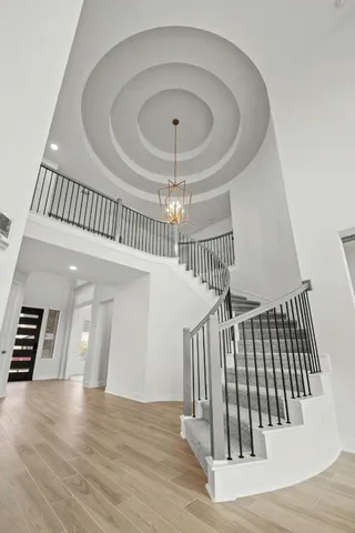 wooden floor with staircase and door in the room