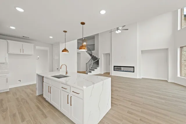 a kitchen with a sink and wooden floor