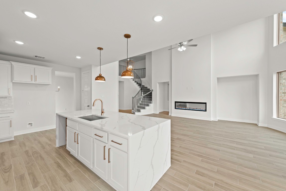 128 Meadow Beauty Lane Georgetown, TX 78633 - Photo 8 of 23 a kitchen with a sink and wooden floor
