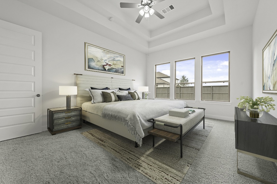 128 Meadow Beauty Lane Georgetown, TX 78633 - Photo 10 of 23 a bedroom with a large bed and a chandelier fan