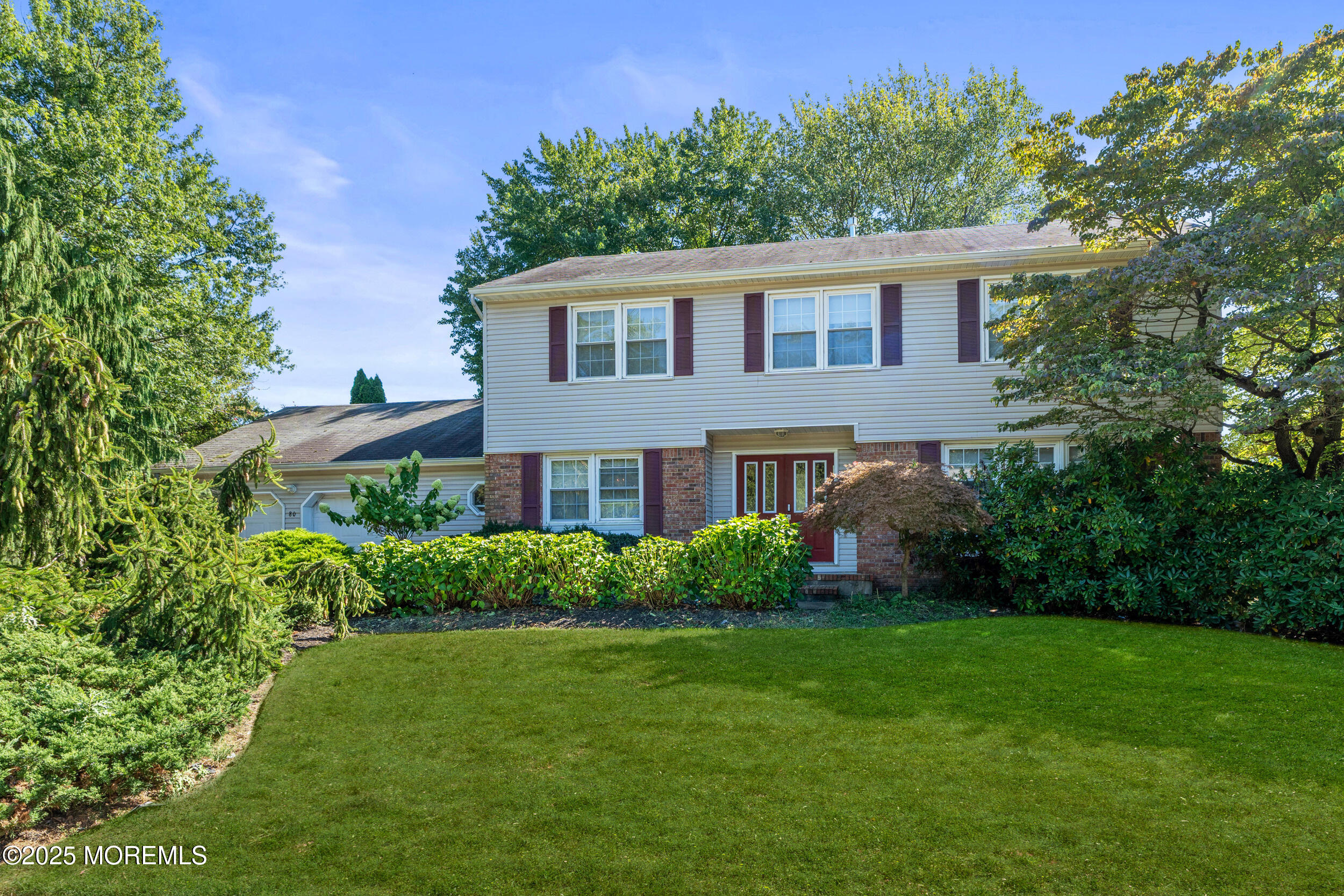 a view of a house with a yard and a garden
