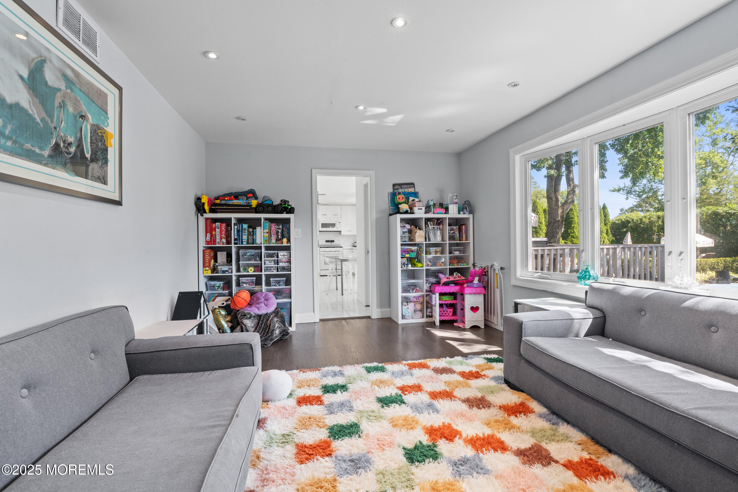 80 Cooper Avenue West Long Branch, NJ 07764 - Photo 12 of 32 a living room with furniture and a book shelf